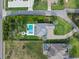 Aerial view of a luxury home featuring a backyard swimming pool with adjacent neighborhood streets at 3865 W Stillwood Ln, Lake Mary, FL 32746