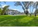 Expansive backyard with a sparkling pool, lounge chairs, and well-maintained lawn at 3865 W Stillwood Ln, Lake Mary, FL 32746