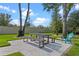 Outdoor patio features a dining area with a stone surface, seating, and a view of the yard at 3865 W Stillwood Ln, Lake Mary, FL 32746