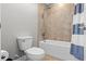 Bathroom showcasing a tub and shower combination with tile surround, alongside a toilet at 3865 W Stillwood Ln, Lake Mary, FL 32746