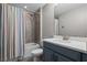 Bathroom with a tiled shower and tub combo, complemented by a vanity and colorful shower curtain at 3865 W Stillwood Ln, Lake Mary, FL 32746