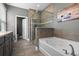 Bathroom featuring soaking tub, glass enclosed shower, and tile flooring at 3865 W Stillwood Ln, Lake Mary, FL 32746