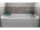 Close up view of a white soaking bathtub with chrome hardware and tile backsplash at 3865 W Stillwood Ln, Lake Mary, FL 32746