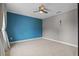 Bedroom with a blue accent wall, ceiling fan, and soft carpet flooring at 3865 W Stillwood Ln, Lake Mary, FL 32746