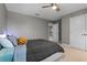 Comfortable bedroom featuring neutral colors, a ceiling fan, and plush pillows for a cozy atmosphere at 3865 W Stillwood Ln, Lake Mary, FL 32746
