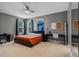 Comfortable bedroom with a ceiling fan, carpet, and two desks, perfect for study or work at 3865 W Stillwood Ln, Lake Mary, FL 32746