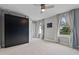 Bedroom featuring a Murphy bed, neutral walls, and ample natural light from two windows at 3865 W Stillwood Ln, Lake Mary, FL 32746