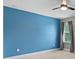 Bedroom with a blue accent wall, ceiling fan, and window that provides natural light at 3865 W Stillwood Ln, Lake Mary, FL 32746