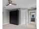Bedroom showcasing a Murphy bed, neutral walls, and doorway to an adjacent bathroom at 3865 W Stillwood Ln, Lake Mary, FL 32746