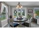 Dining area features a round wooden table and chairs, with views of the backyard and pool at 3865 W Stillwood Ln, Lake Mary, FL 32746