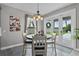 Cozy dining area with a round table, modern light fixture, and view to the backyard at 3865 W Stillwood Ln, Lake Mary, FL 32746