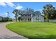 Charming two-story home with manicured lawn, brick driveway, mature trees, and a bright yellow front door at 3865 W Stillwood Ln, Lake Mary, FL 32746