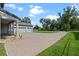 Attached three-car garage with paved driveway and manicured landscaping at 3865 W Stillwood Ln, Lake Mary, FL 32746
