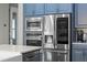Modern stainless steel appliances, including a built-in microwave, oven, and a sleek refrigerator at 3865 W Stillwood Ln, Lake Mary, FL 32746