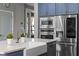 Modern kitchen with stainless steel appliances and a farmhouse sink at 3865 W Stillwood Ln, Lake Mary, FL 32746