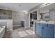 Open bathroom showcasing blue cabinets, white tile floors and neutral paint at 3865 W Stillwood Ln, Lake Mary, FL 32746