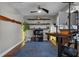 Bright home office with floating shelves, ceiling fan, and hard wood flooring at 3865 W Stillwood Ln, Lake Mary, FL 32746