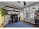 Well-lit office space with modern ceiling fan, floating shelves, and blue patterned rug at 3865 W Stillwood Ln, Lake Mary, FL 32746