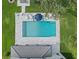 Aerial view of a sparkling pool surrounded by a stone patio, lounge chairs, and an umbrella at 3865 W Stillwood Ln, Lake Mary, FL 32746