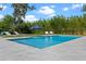 Beautiful pool area with ample seating and lush greenery creating a private oasis at 3865 W Stillwood Ln, Lake Mary, FL 32746