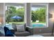 Living room view of the backyard featuring a private pool and lush landscaping at 3865 W Stillwood Ln, Lake Mary, FL 32746