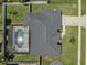 Aerial view of roof and backyard area showing screened pool enclosure and neighboring yards at 445 Oakland Park Blvd, Port Orange, FL 32127