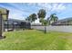 Spacious backyard featuring a screened-in pool area and lush green grass at 445 Oakland Park Blvd, Port Orange, FL 32127