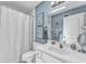 Bathroom with a white vanity, framed art, and shower with white curtain at 445 Oakland Park Blvd, Port Orange, FL 32127