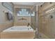 Bright bathroom featuring a soaking tub and glass-enclosed shower at 445 Oakland Park Blvd, Port Orange, FL 32127