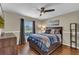 Comfortable bedroom featuring a bed with built in drawers and wood laminate flooring at 445 Oakland Park Blvd, Port Orange, FL 32127