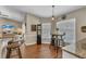 Cozy breakfast nook with a round table, barstool seating, and natural light from the window at 445 Oakland Park Blvd, Port Orange, FL 32127