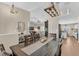 Open-concept dining area with modern lighting, a large dining table, and views into the living room and kitchen at 445 Oakland Park Blvd, Port Orange, FL 32127