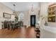 Spacious dining room area with a modern chandelier, beautiful flooring, and natural light at 445 Oakland Park Blvd, Port Orange, FL 32127