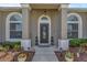 An inviting front entrance with decorative plants, updated lighting, and a modern front door design at 445 Oakland Park Blvd, Port Orange, FL 32127