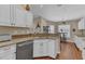 Bright kitchen featuring granite countertops, white cabinets, and bar seating area at 445 Oakland Park Blvd, Port Orange, FL 32127