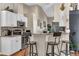 Eat-in kitchen bar features granite countertops, pendant lighting, and white cabinetry at 445 Oakland Park Blvd, Port Orange, FL 32127