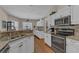 Well-equipped kitchen with stainless steel appliances, granite counters, and white cabinetry at 445 Oakland Park Blvd, Port Orange, FL 32127