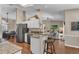Open kitchen with stainless appliances, breakfast bar, and seamless transition to living and dining areas at 445 Oakland Park Blvd, Port Orange, FL 32127