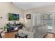 A well-lit living room featuring a fireplace, entertainment center, and sliding glass doors to the pool area at 445 Oakland Park Blvd, Port Orange, FL 32127
