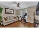 Well-lit room featuring a stationary bicycle, sofa, and wood laminate flooring at 445 Oakland Park Blvd, Port Orange, FL 32127
