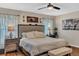 Comfortable main bedroom with wood laminate flooring, ceiling fan, and neutral decor at 445 Oakland Park Blvd, Port Orange, FL 32127