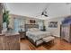 Comfortable main bedroom with wood laminate flooring, ceiling fan, and neutral decor at 445 Oakland Park Blvd, Port Orange, FL 32127