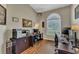 Bright home office with vaulted ceiling, multiple workspaces, and natural light from a large window at 445 Oakland Park Blvd, Port Orange, FL 32127