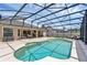 Sparkling pool inside a screened enclosure and connected to the home at 445 Oakland Park Blvd, Port Orange, FL 32127