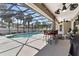 Screened pool area featuring outdoor seating and a ceiling fan at 445 Oakland Park Blvd, Port Orange, FL 32127