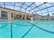 Sparkling pool with sun shelf inside a screened enclosure and connected to the home at 445 Oakland Park Blvd, Port Orange, FL 32127