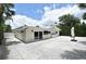 Expansive backyard featuring a white pebble ground cover, creating a serene outdoor living space at 507 N Peninsula Ave, New Smyrna Beach, FL 32169