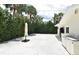 White pebble backyard surrounded by lush greenery, creating a private and tranquil outdoor space at 507 N Peninsula Ave, New Smyrna Beach, FL 32169