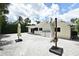 Exterior view of the back of the home featuring a backyard covered in gravel, with two patio umbrellas at 507 N Peninsula Ave, New Smyrna Beach, FL 32169