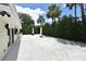 Backyard featuring a white pebble ground cover and privacy hedges, ideal for outdoor gatherings at 507 N Peninsula Ave, New Smyrna Beach, FL 32169
